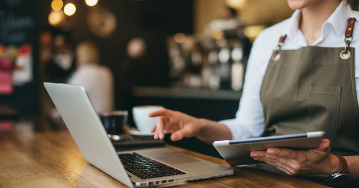 Business owner checking website on laptop